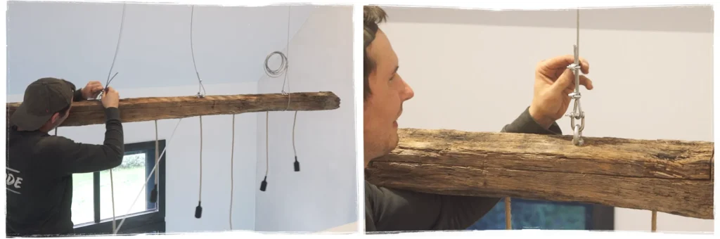 Suspension d’une poutre en bois ancien transformée en luminaire à l’aide d’élingues métalliques à Mazé
